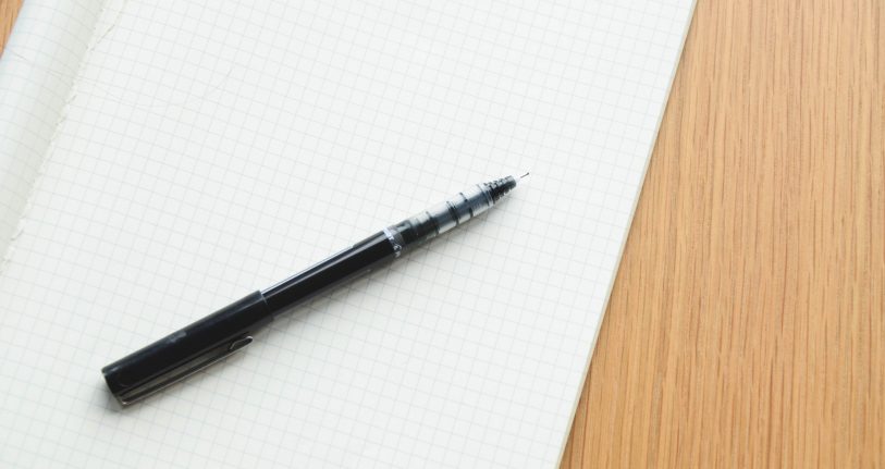 Pen and pad on desk. Image source: Startup Stock Photos